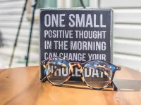 Photo of a sign and eyeglasses on table 1485657